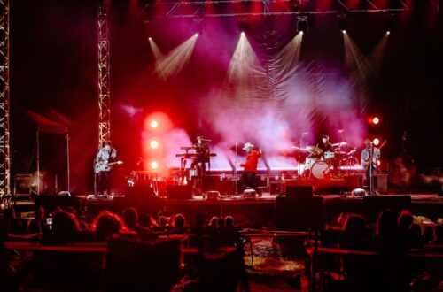 Crowd enjoying live music at a local venue with food stalls and vibrant atmosphere