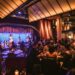 Friends enjoying live music and dining at a vibrant restaurant for a perfect night out